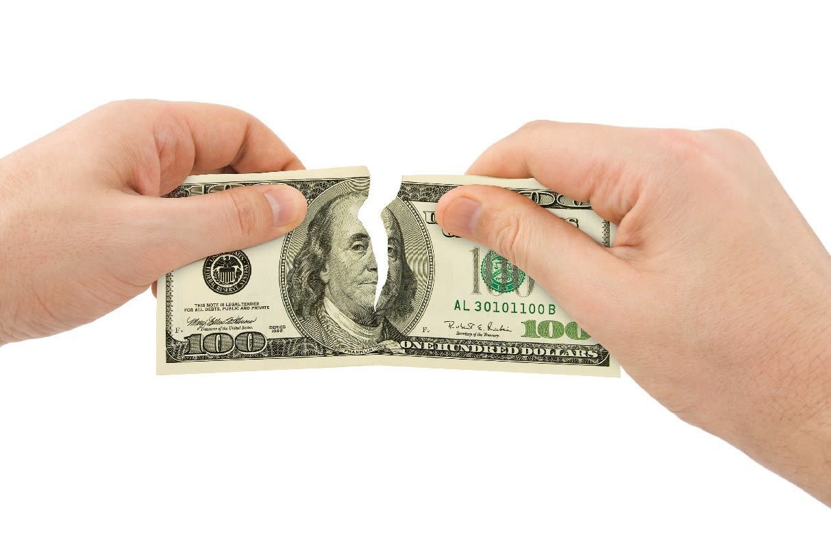 Hands Ripping 100 Dollar Bill