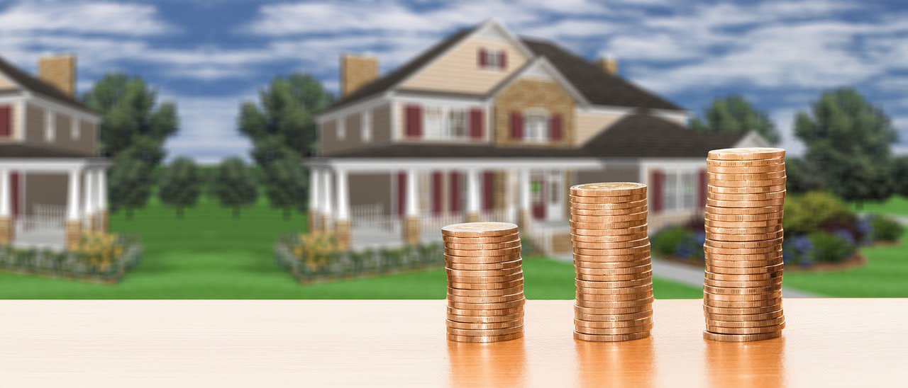 Two Stories House and Stack of Coins
