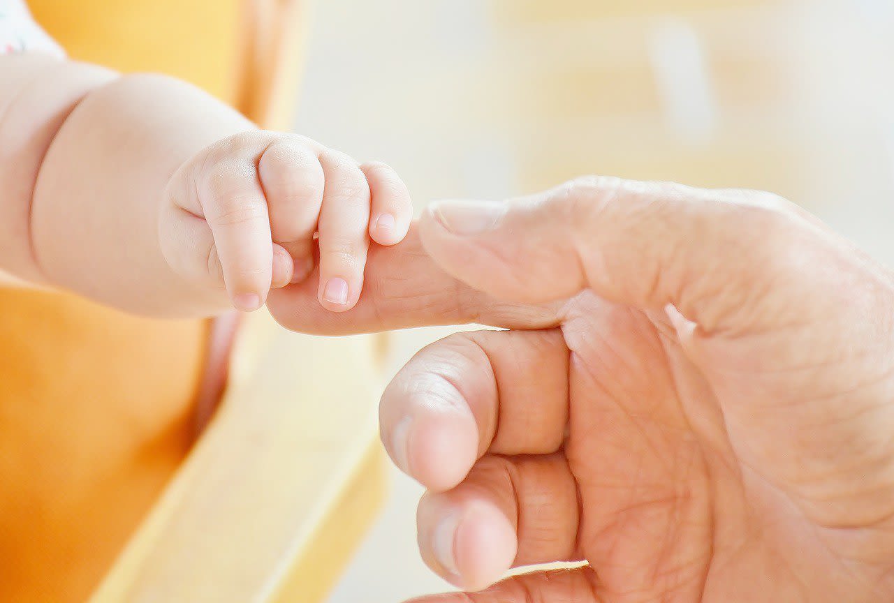 Baby Hands Holding Adult's finger