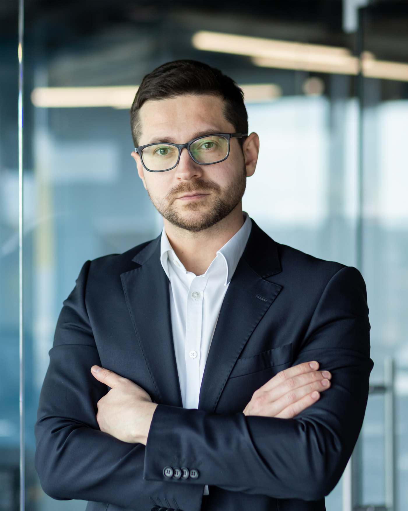 Portrait of a young lawyer in a suit and glasses