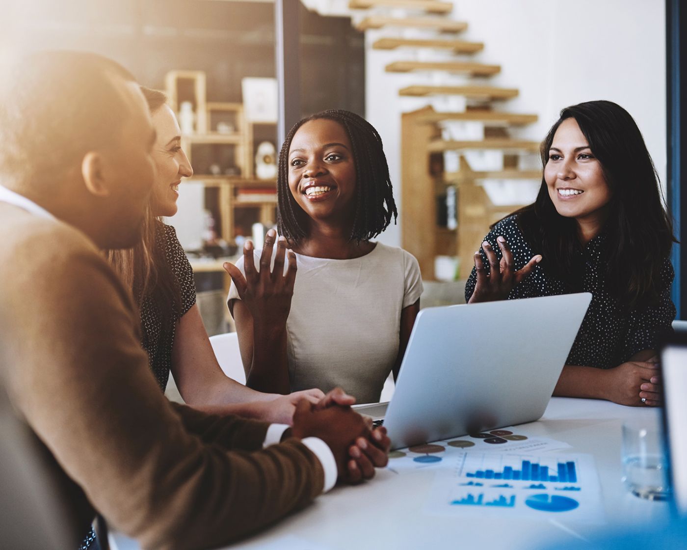 A black woman giving a business presentation to her peers.