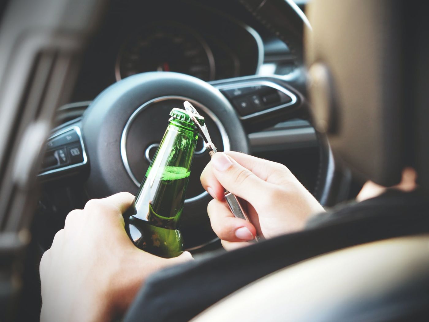 opening a beer in a car