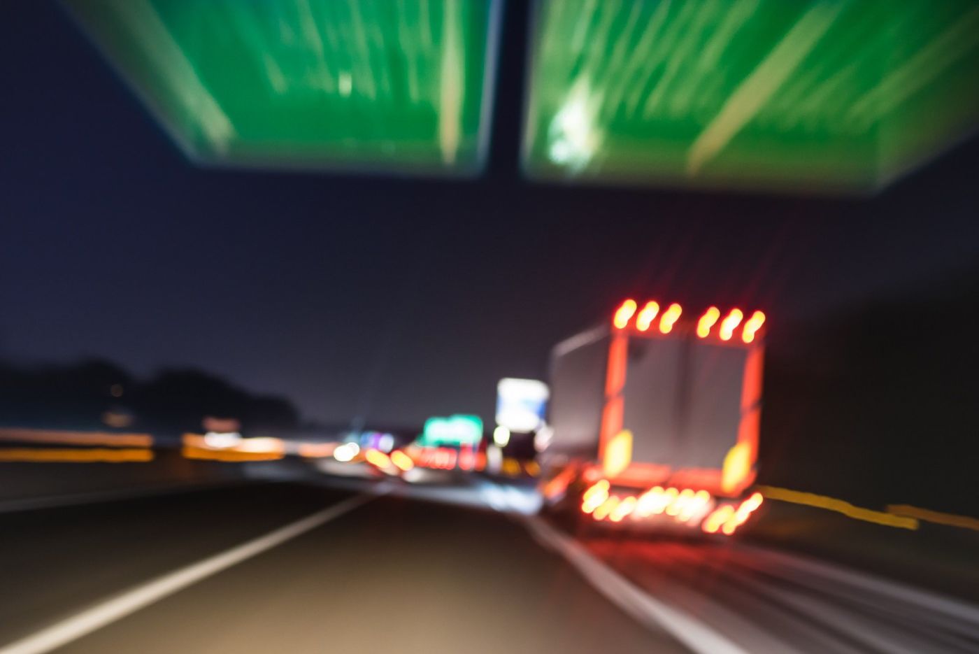 Big Trucks with lights on back driving on highway