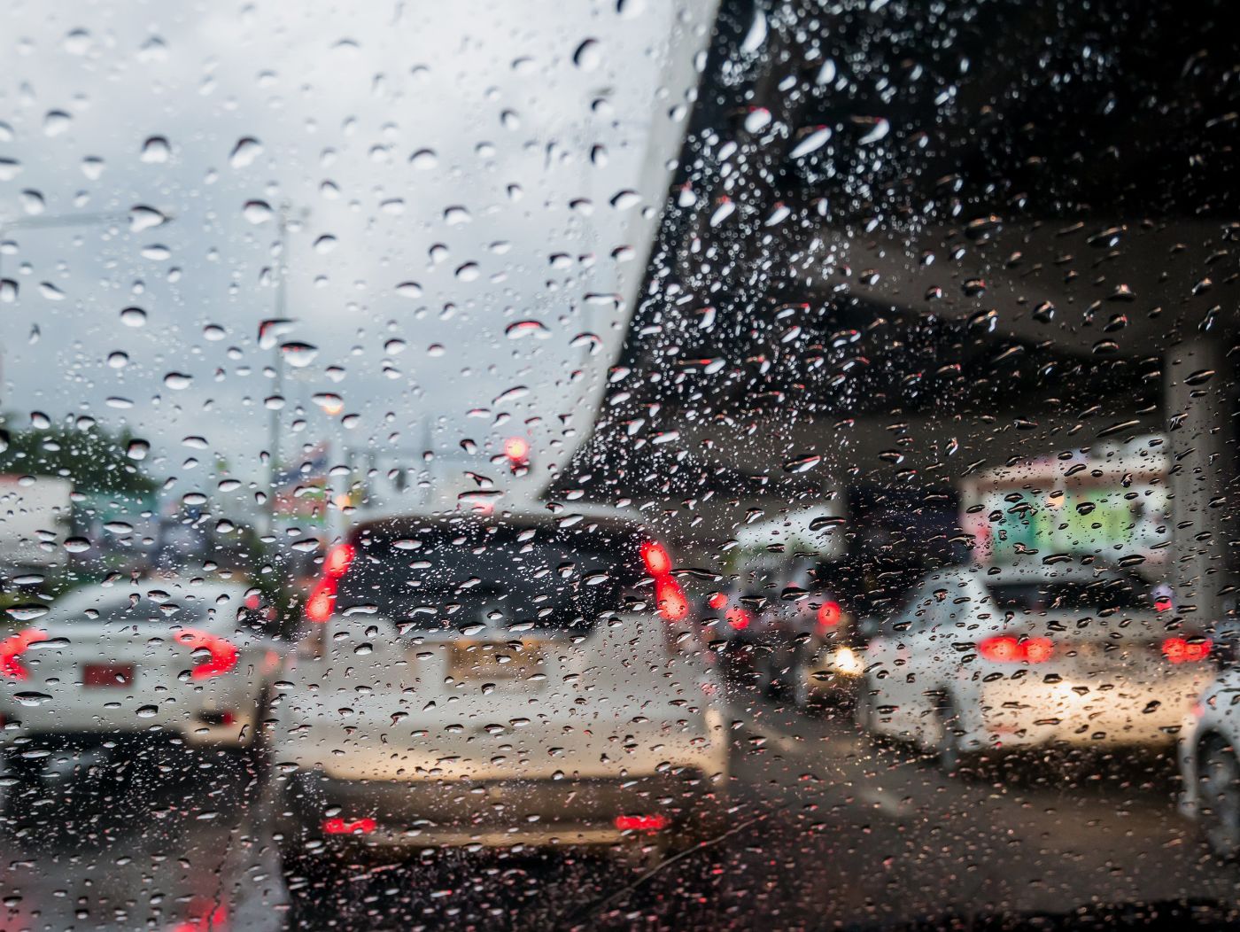 Rain on windshield, car in front