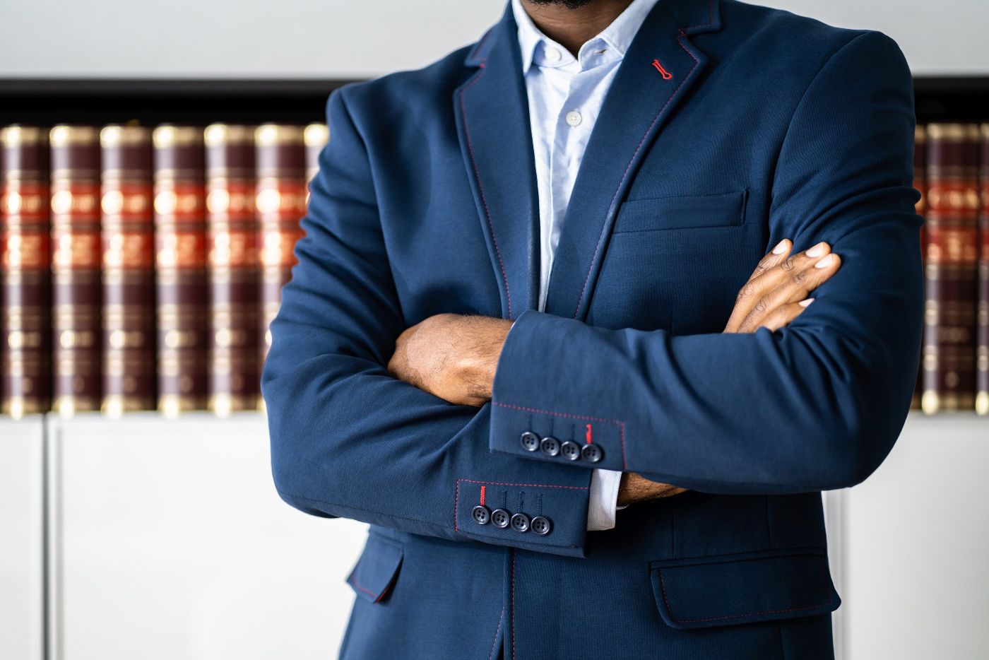 Man in blue suit with arms cross