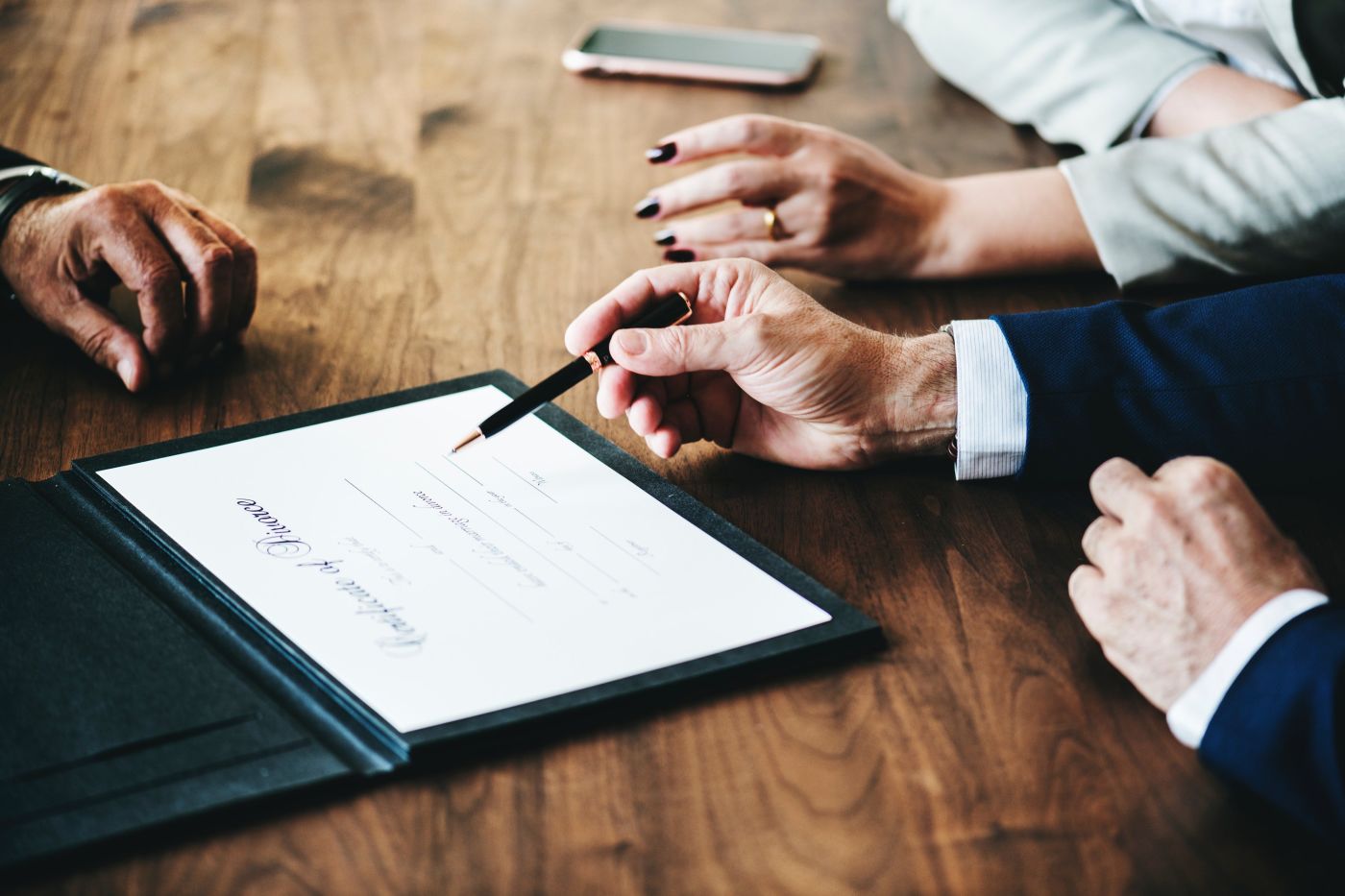 Lawyer signing divorce papers with couple