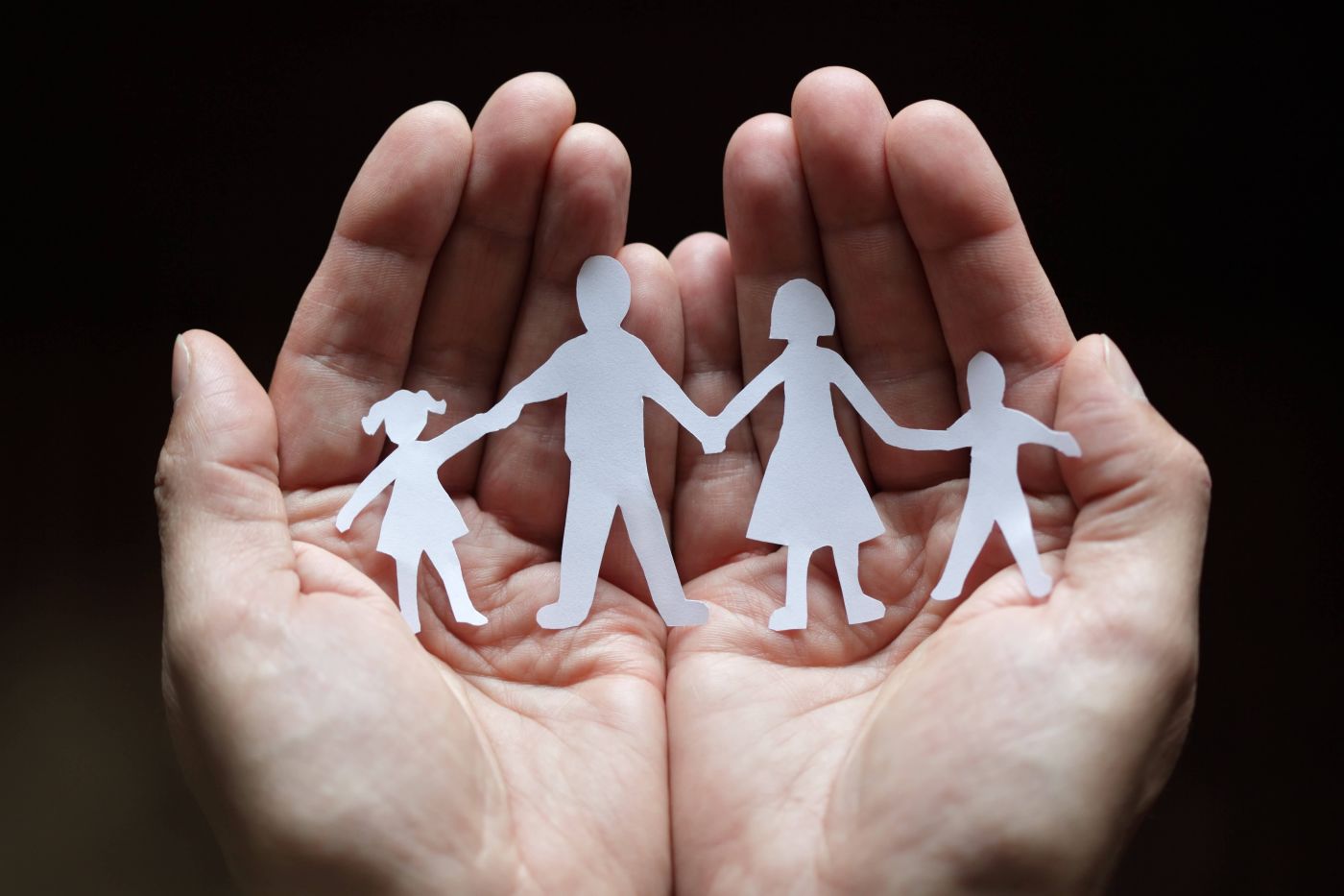 hands holding paper family