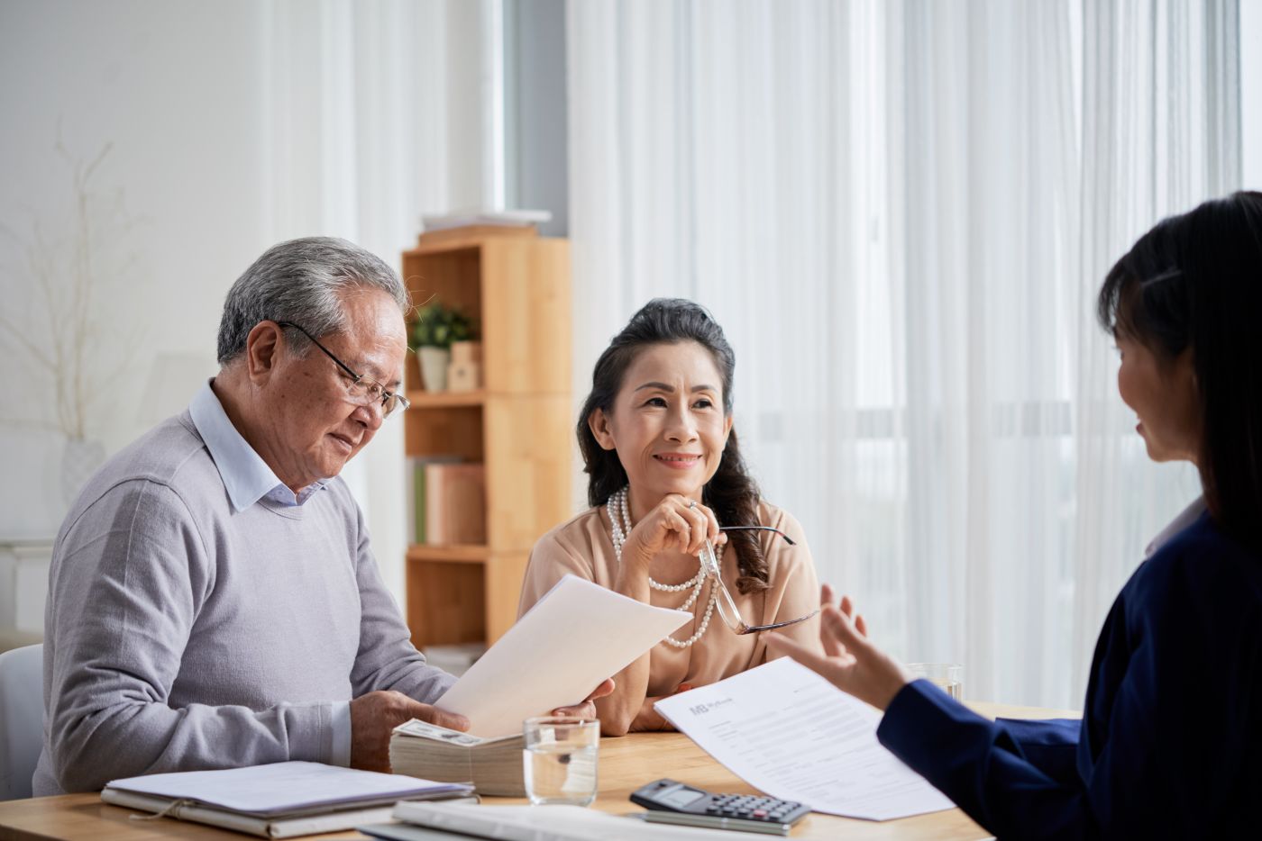 Older couple reviewing documents with an attorney.jpeg
