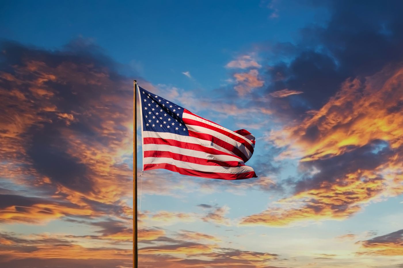 American flagon a pole at sunset