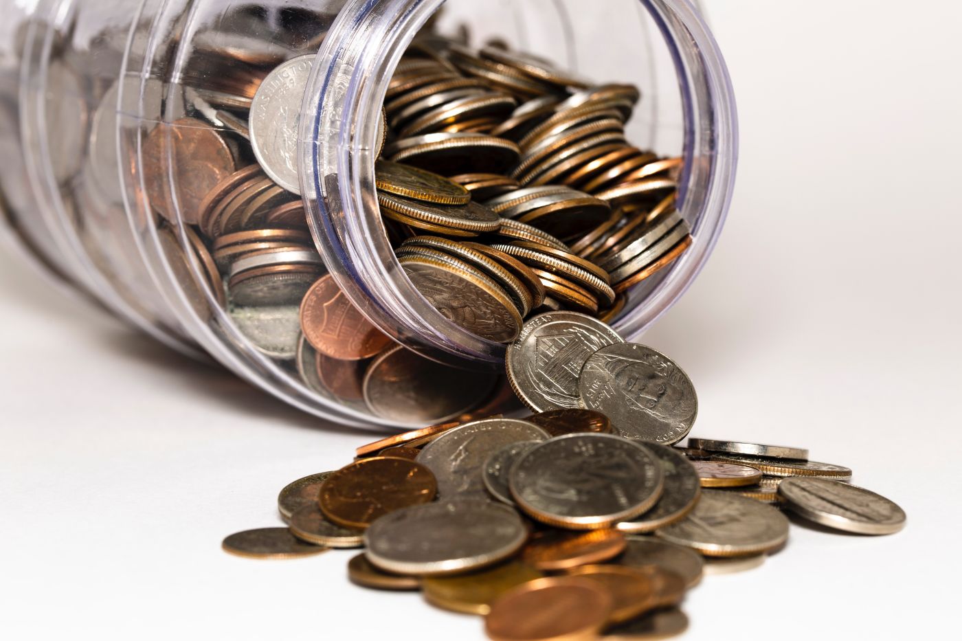Coins Spilling from A Jar