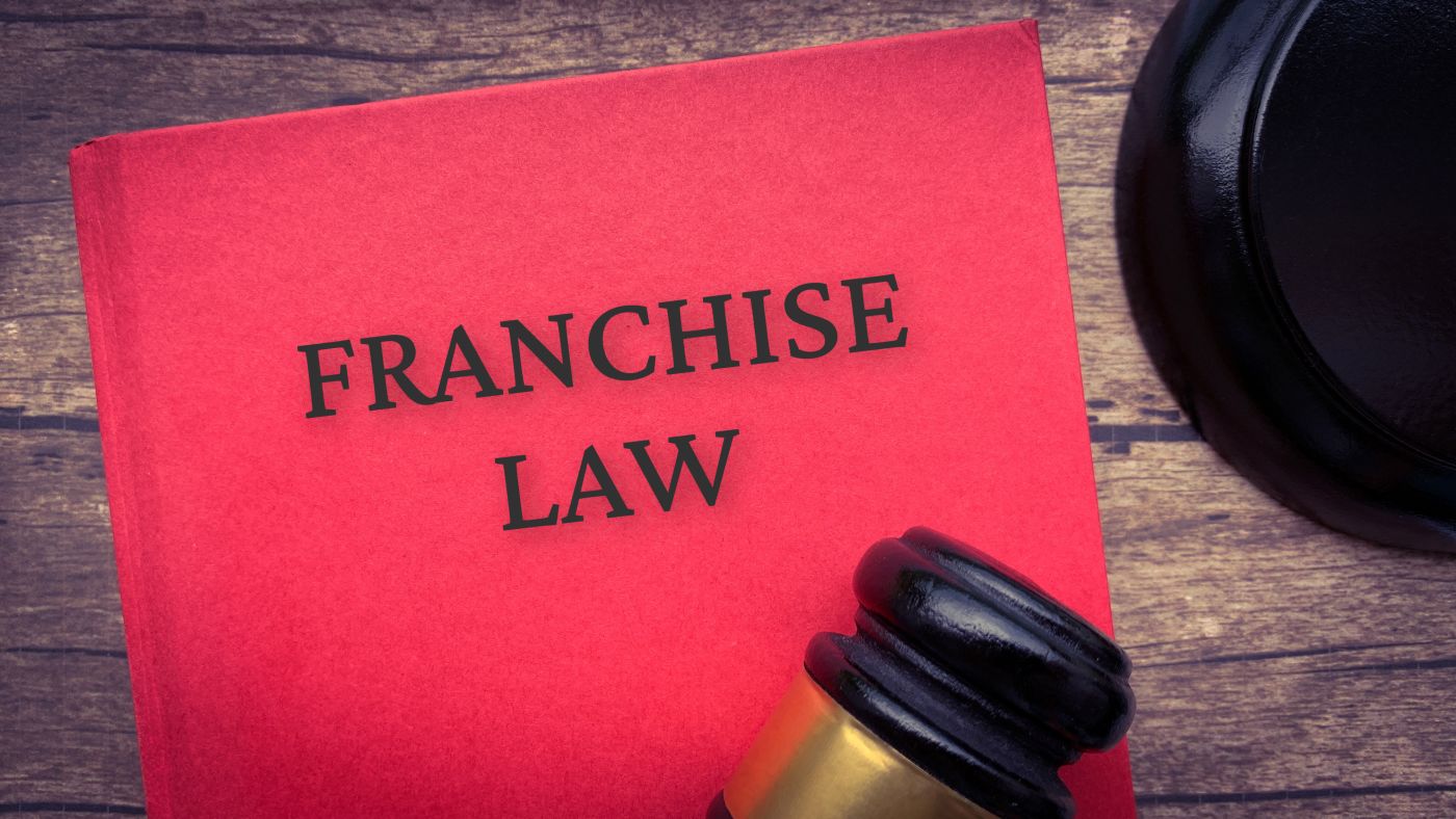 Franchise law book and gavel on wooden table