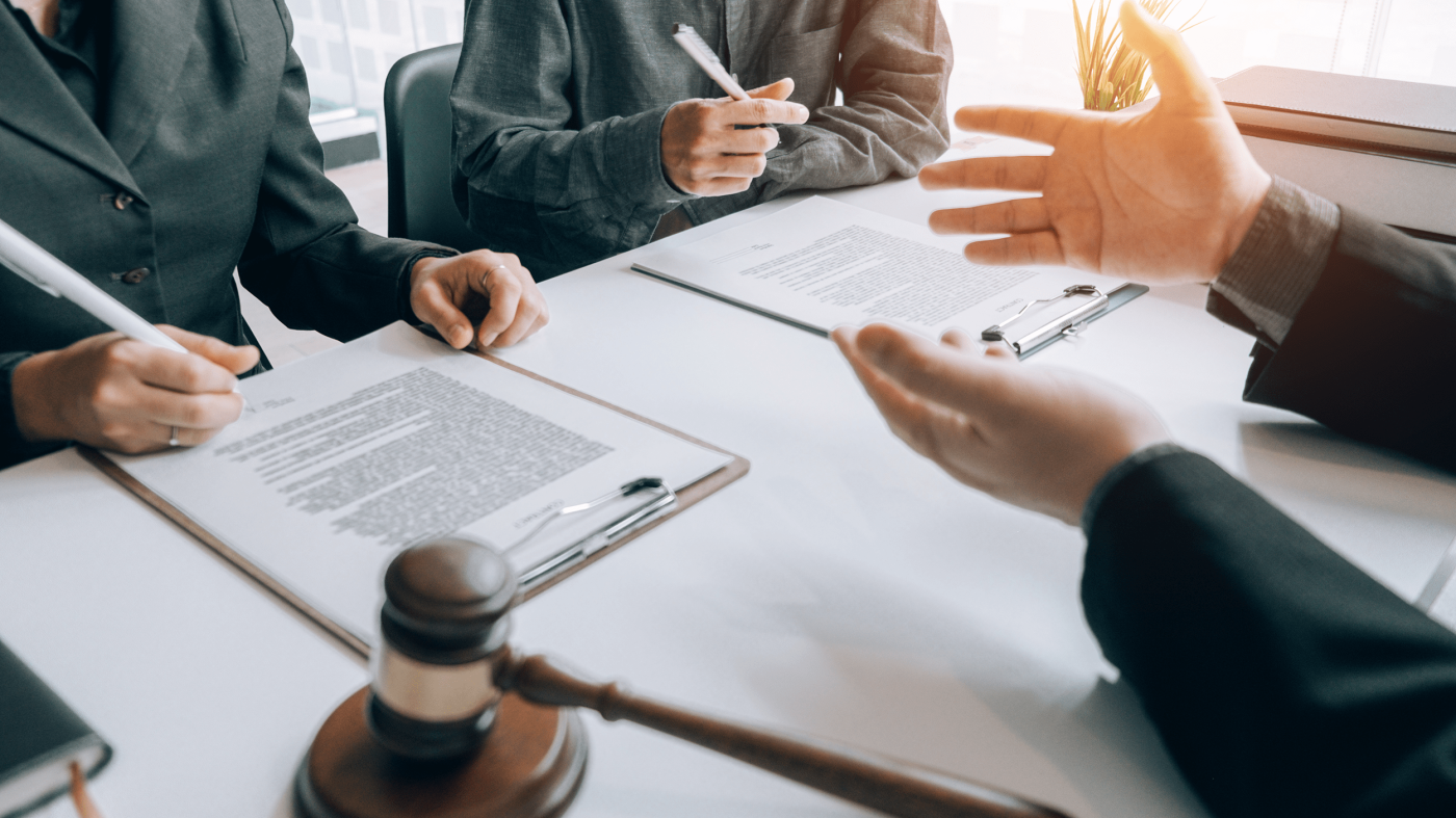 Businessman and lawyer discuss the contract document.