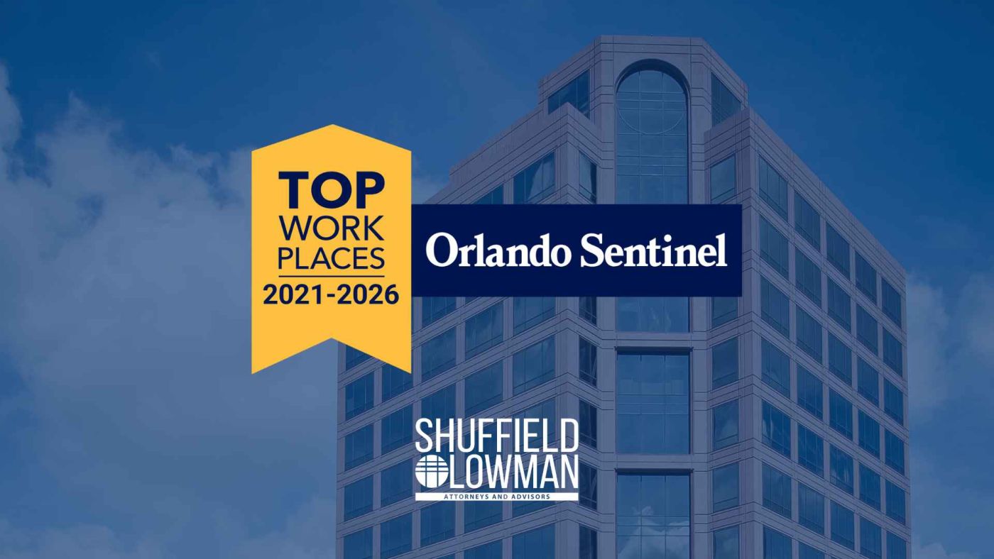 Tall brick building with windows. Transparent blue overlay over image. Yellow banner saying top workplaces 2021-2026 attached to dark blue banner that says Orlando Sentinel in the center. ShuffieldLowman logo in bottom.