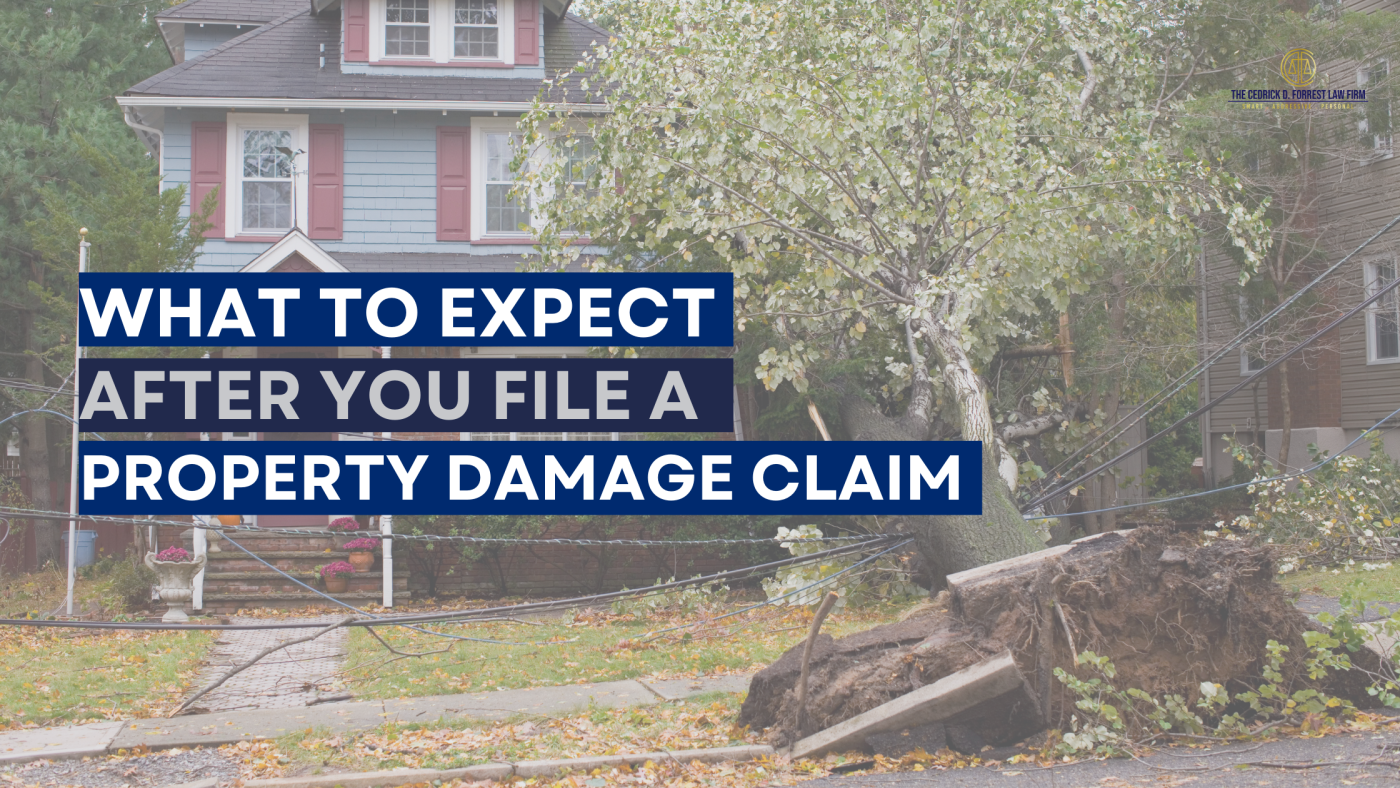 Image of a house with a large uprooted tree fallen over onto the roof. The text overlay reads "what to expect after you file a property damage claim," indicating a topic related to property damage insurance claims.