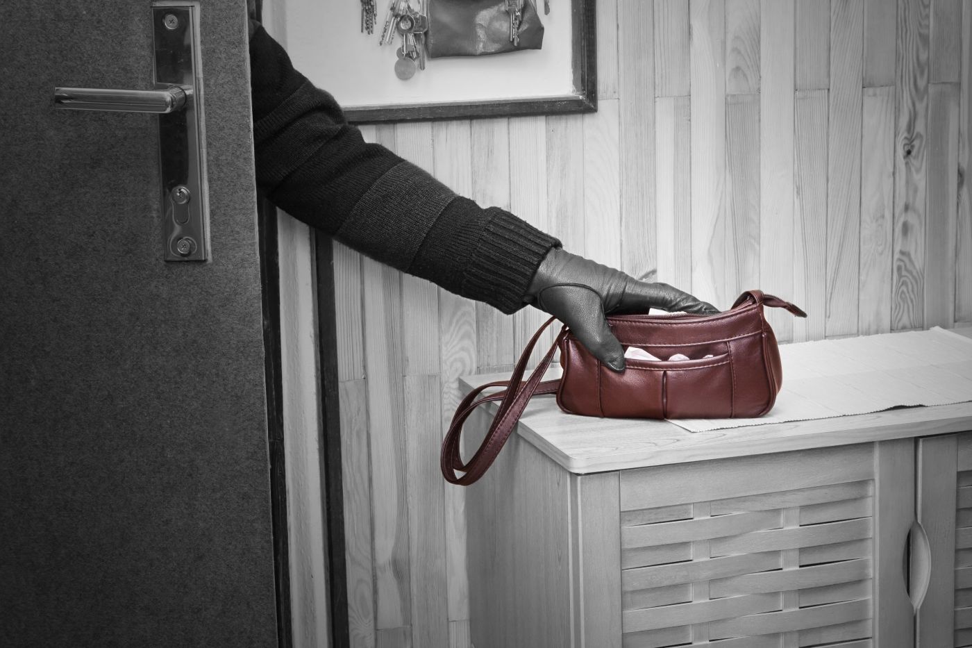 Burglar stealing purse by breaking into house