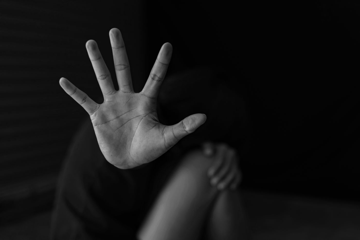 Women showing hands signaling to stop domestic violence