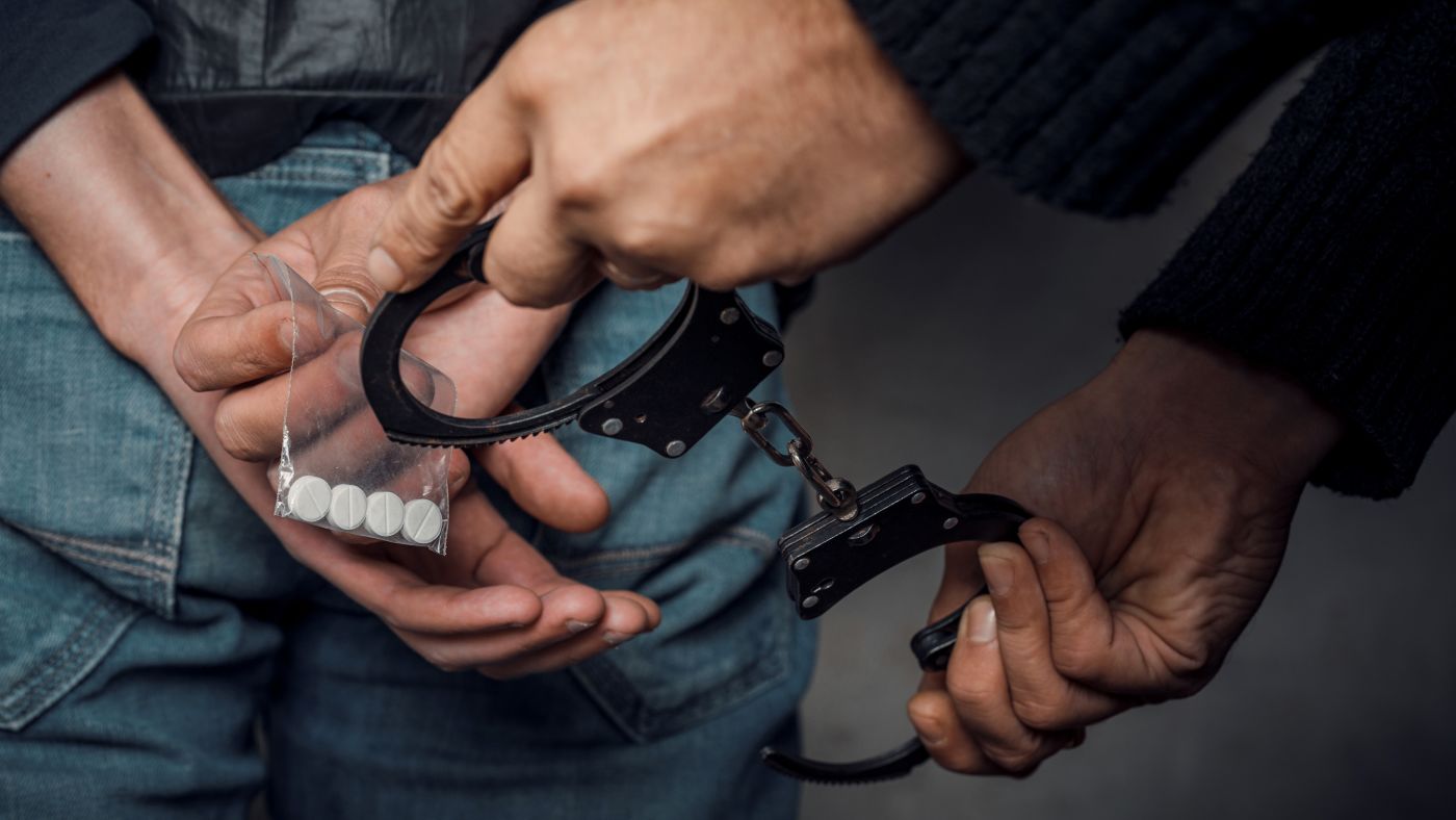 Man being handcuffed for drug possession