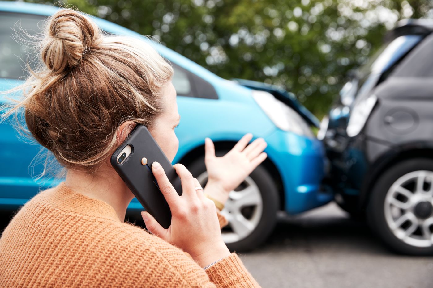 Women calling for helping on phone after car accident