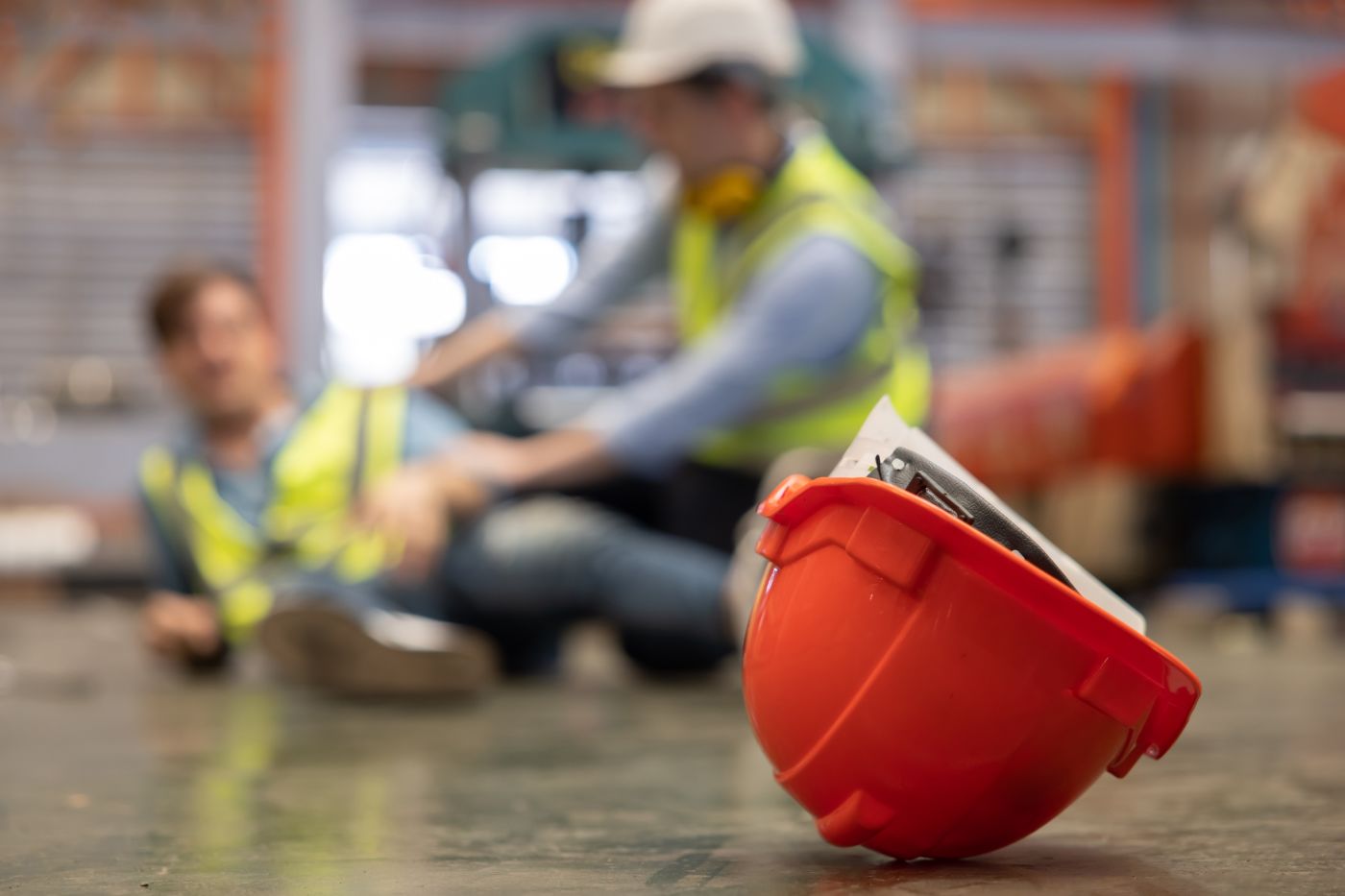 Worker helping Injured worker on floor