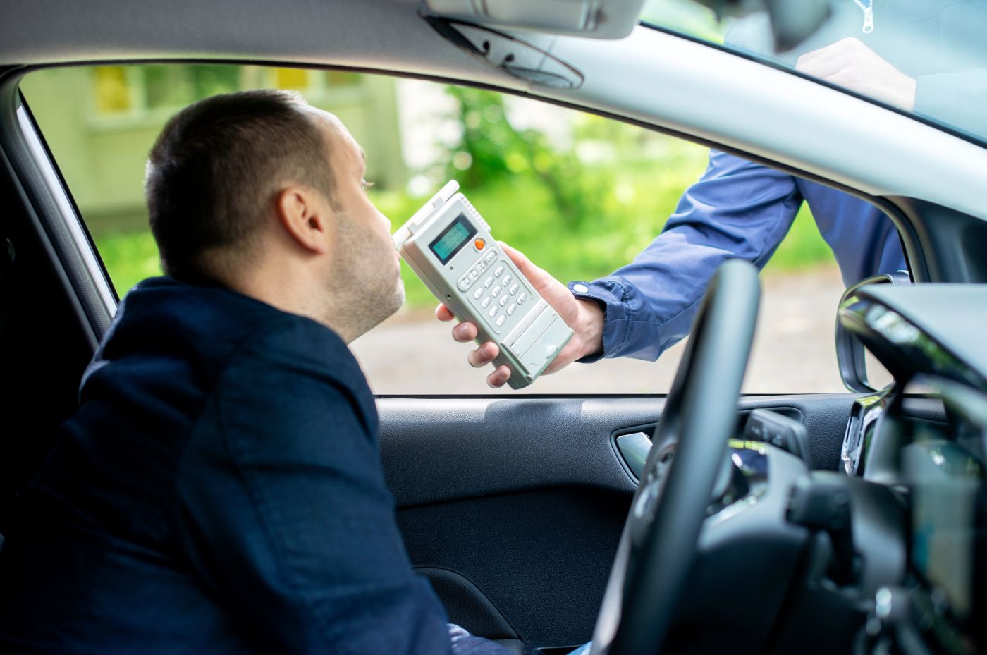Driver blowing into breathalyzer