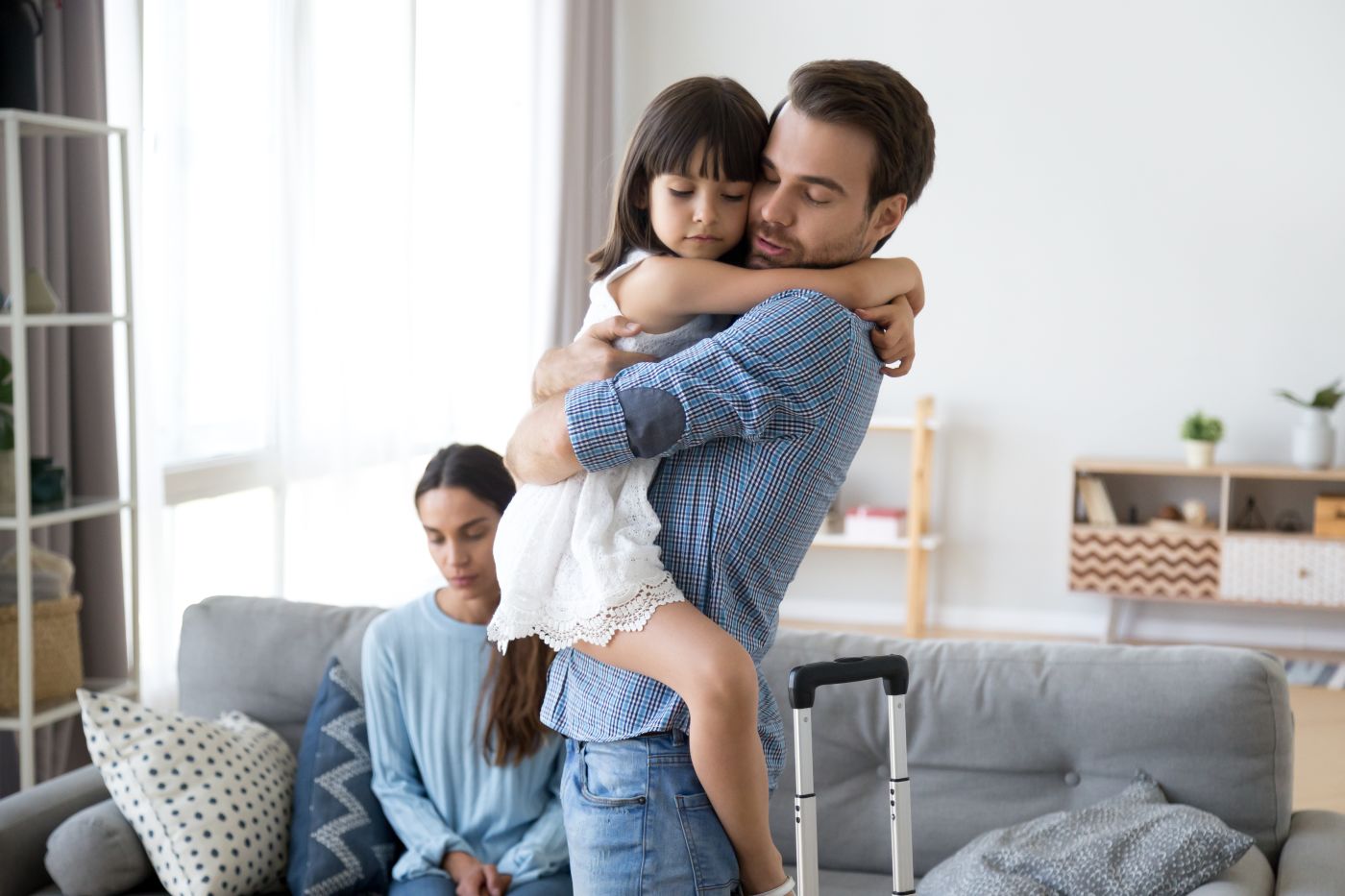 Little girl hugging dad who is moving out