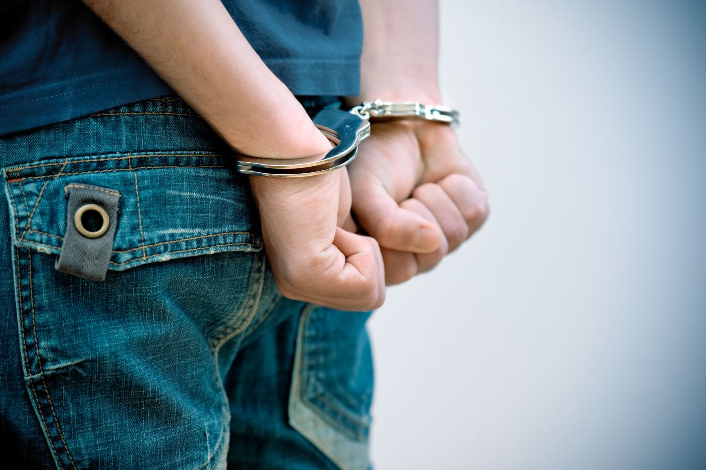 Handcuffed hand of a teenager