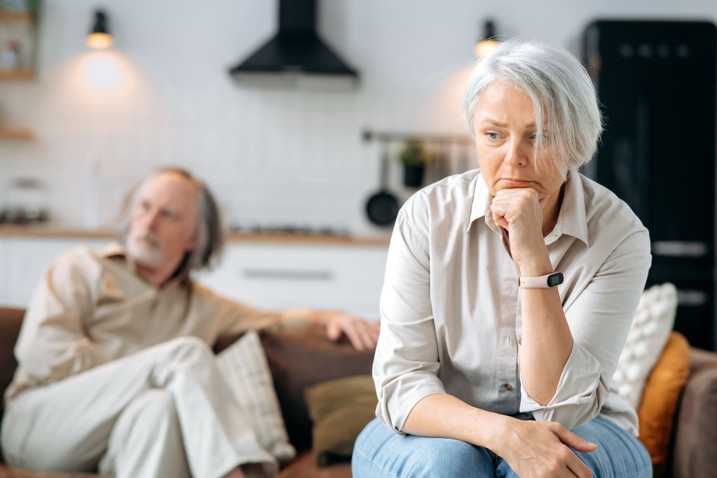 Senior couple sitting apart from each other after quarrel