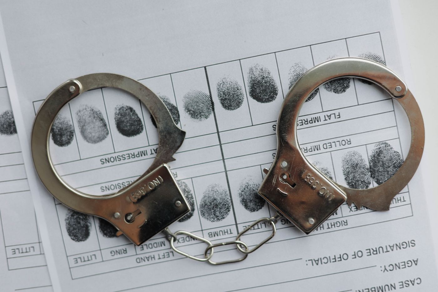 Handcuff and fingerprint record in a criminal record sheet