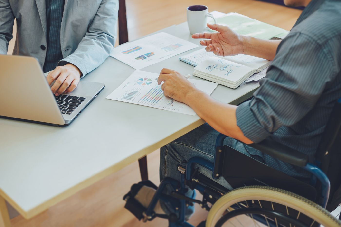 Man in wheelchair working in office