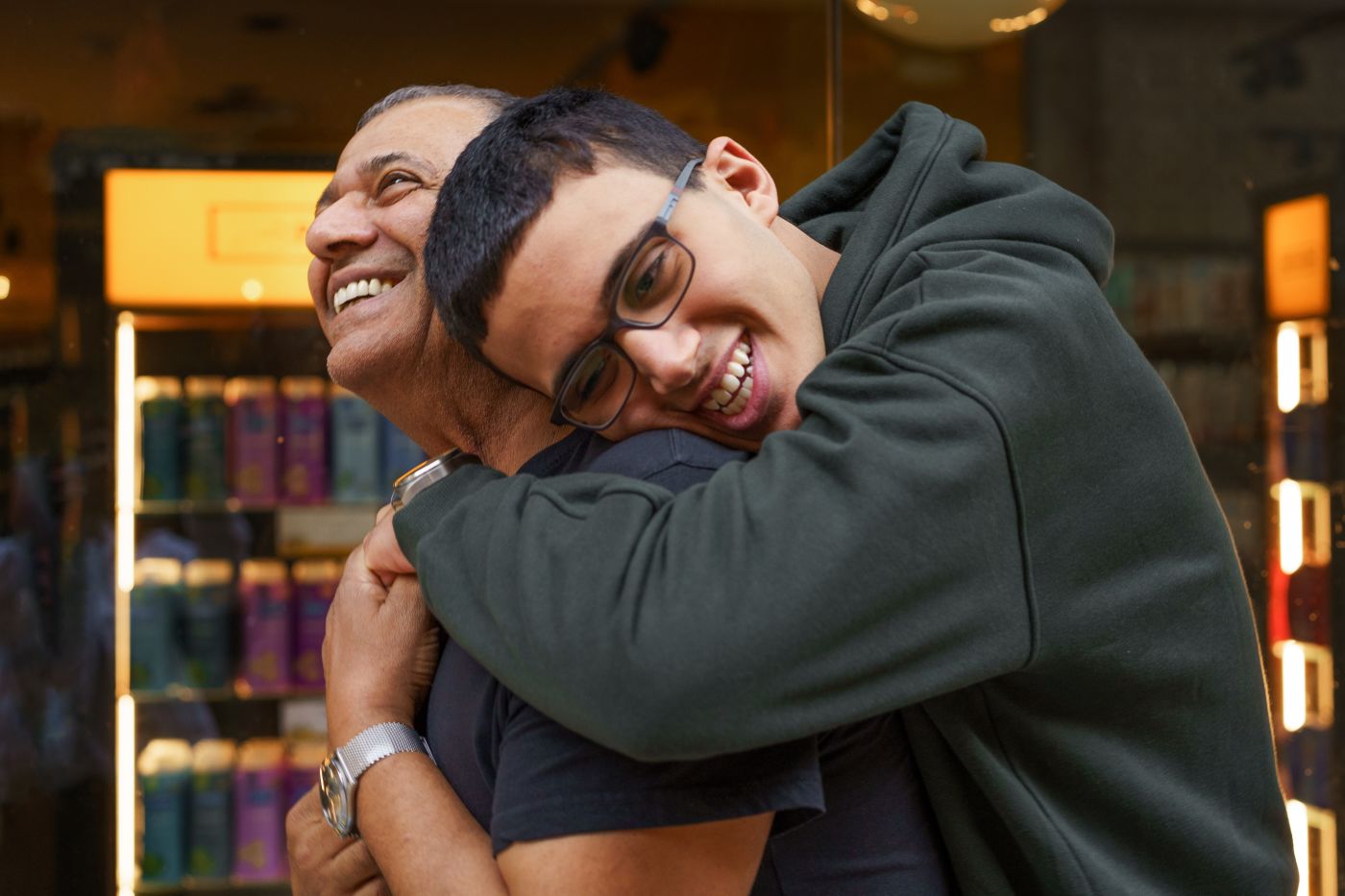 Special need teenager hugs his father