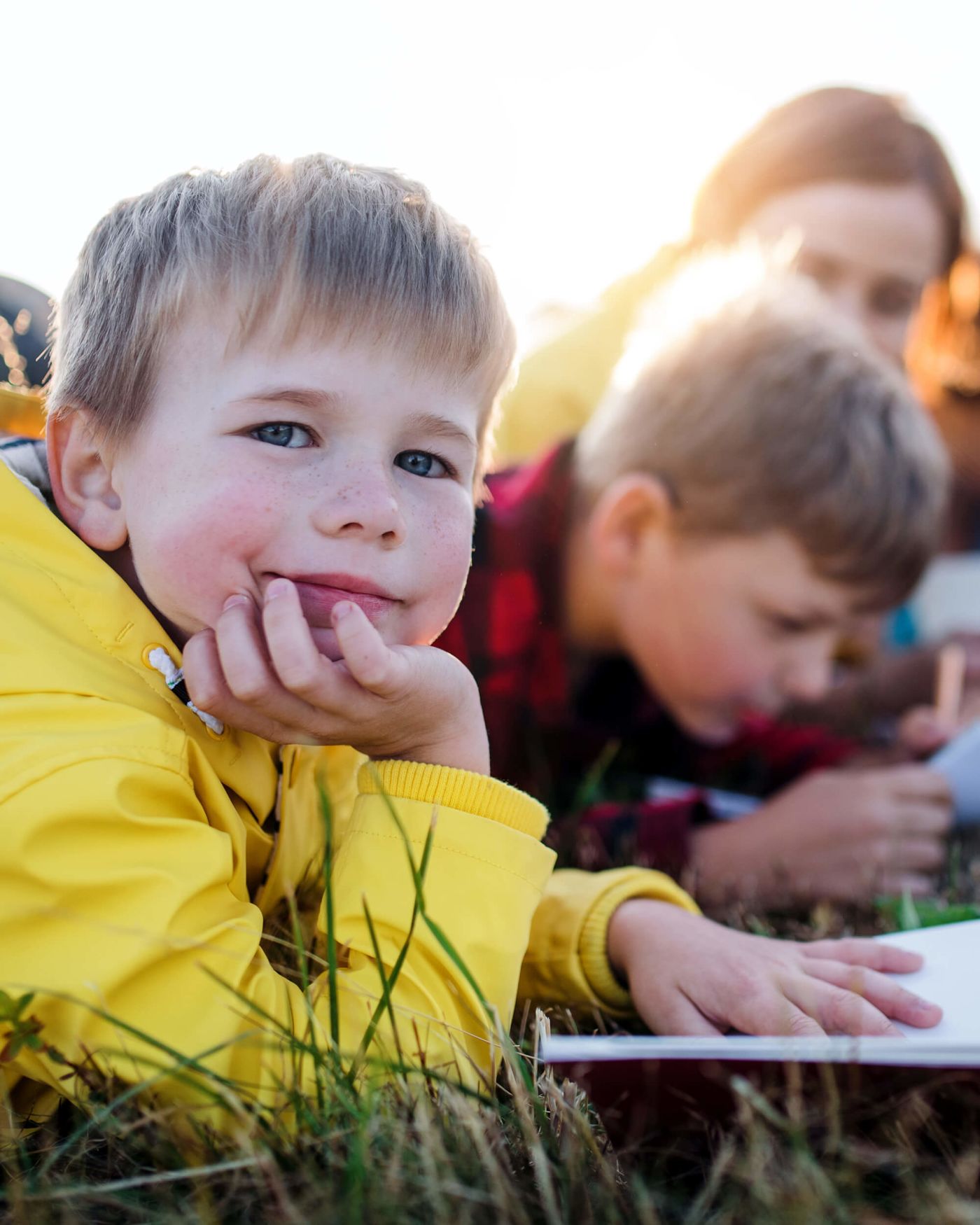 Group of school children with teacher on field trip in nature.