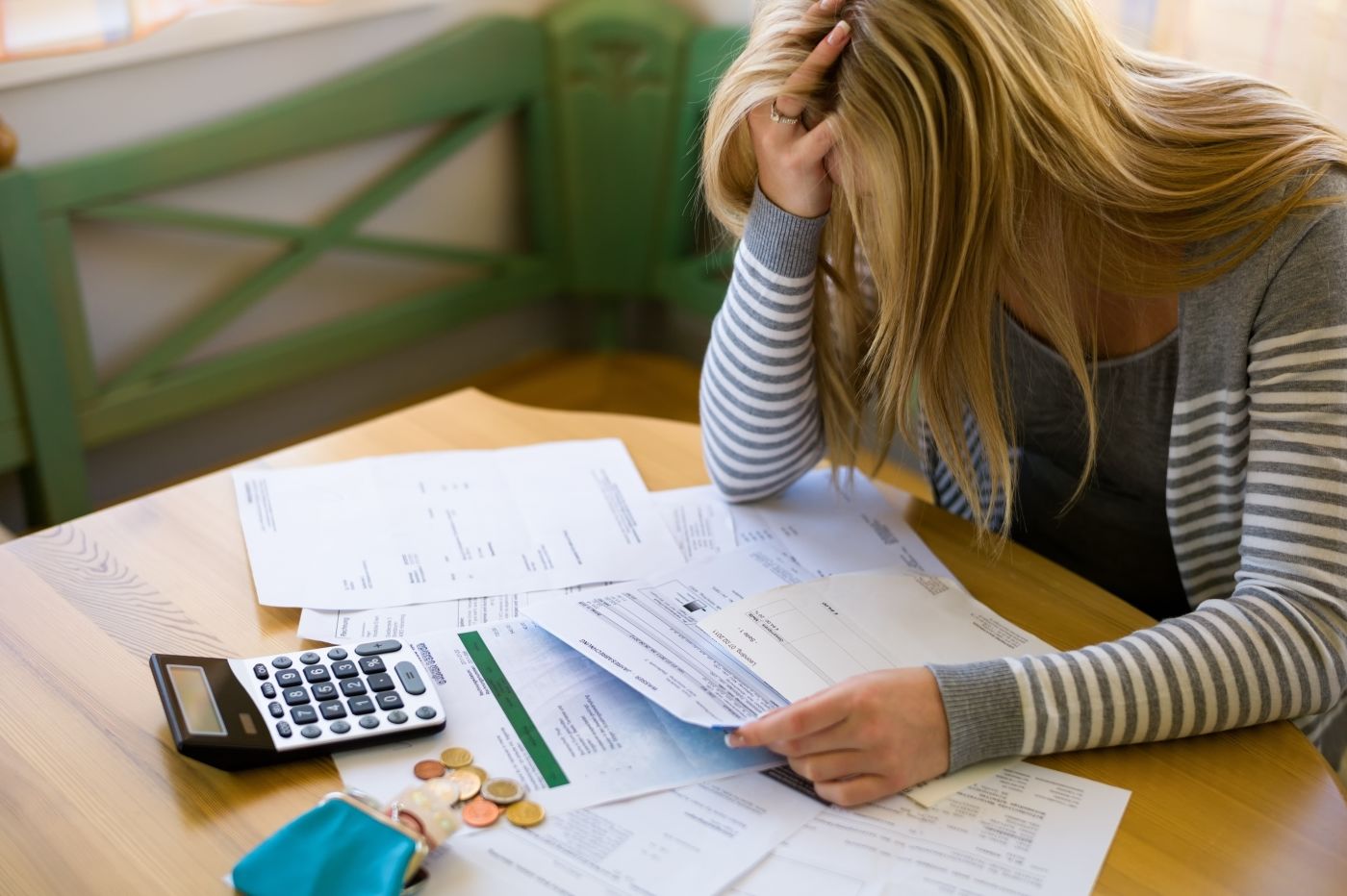 Frustrated women with unpaid bills on hand