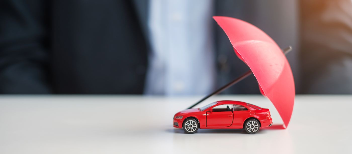 Red car under umbrella, Auto Insurance Concept