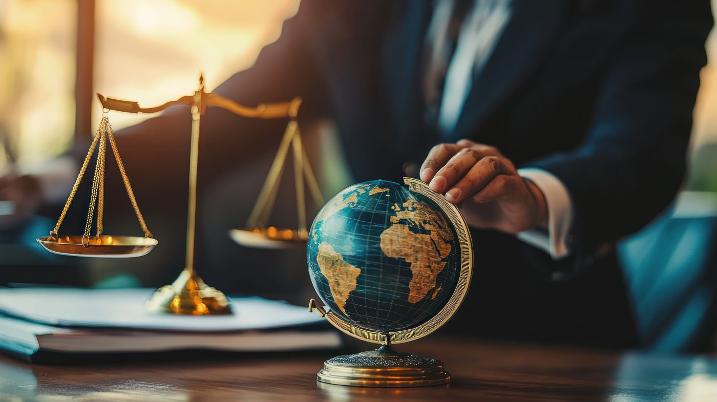 Attorney in office with globe and scale of justice