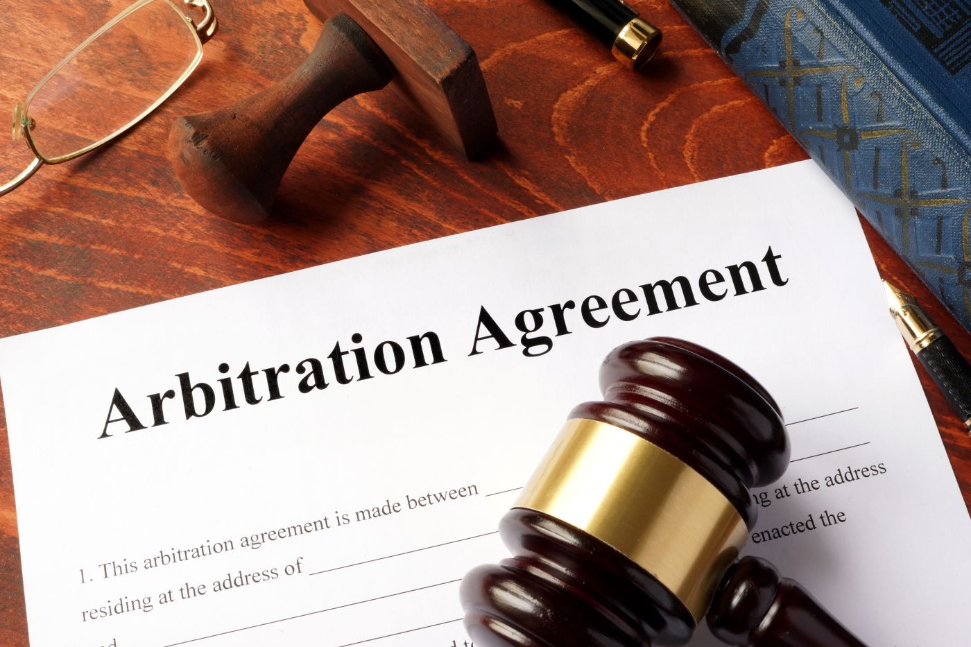 Arbitration agreement form and gavel on an office table