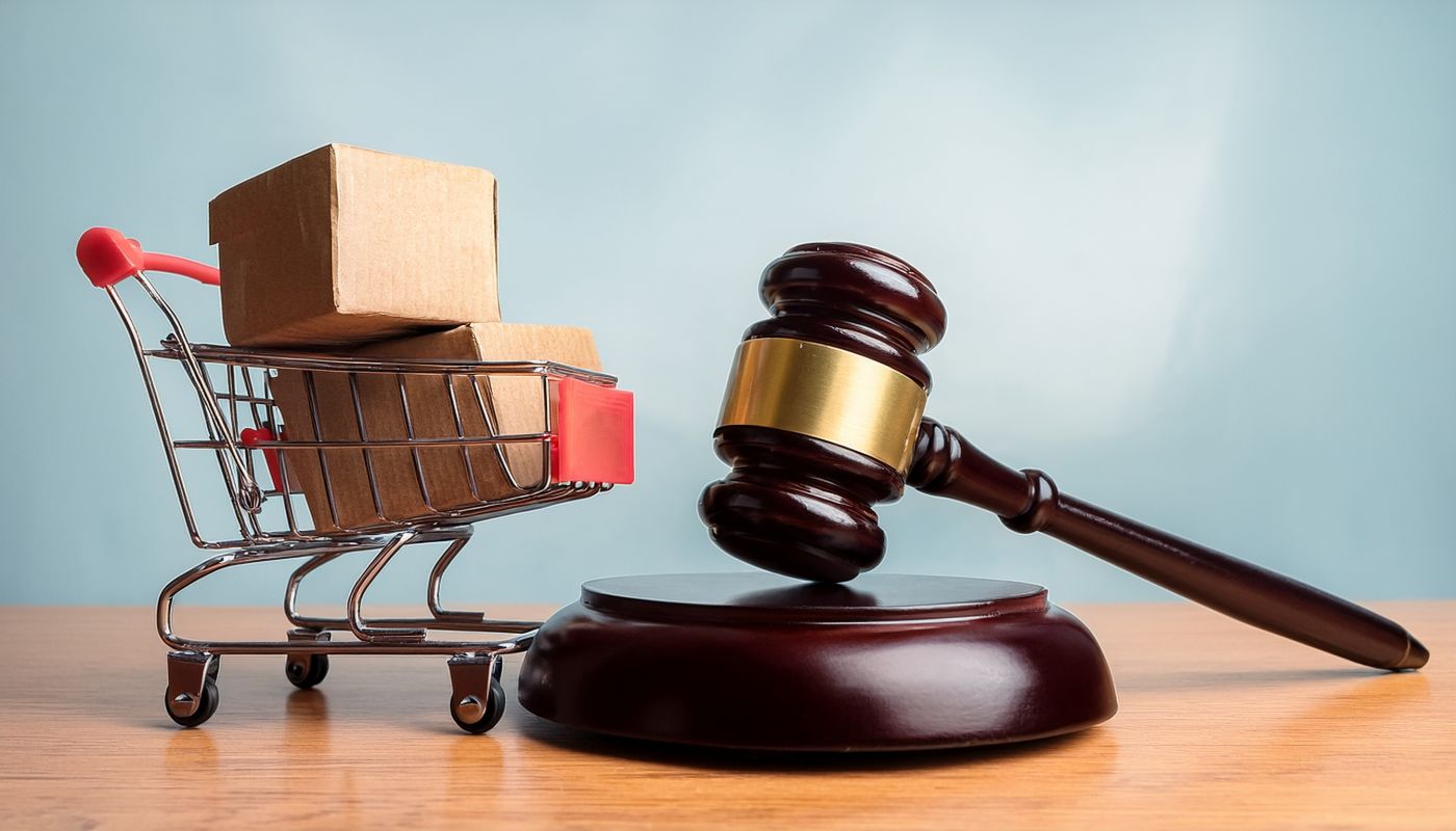 Gavel and shopping cart with boxes representing consumer rights