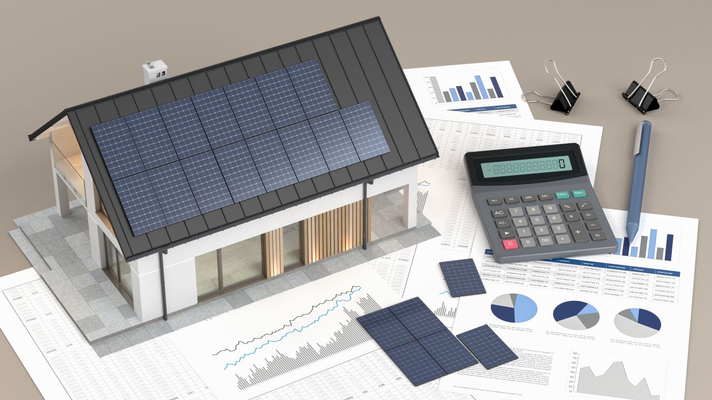 House with photovoltaic solar panel, calculator and documents