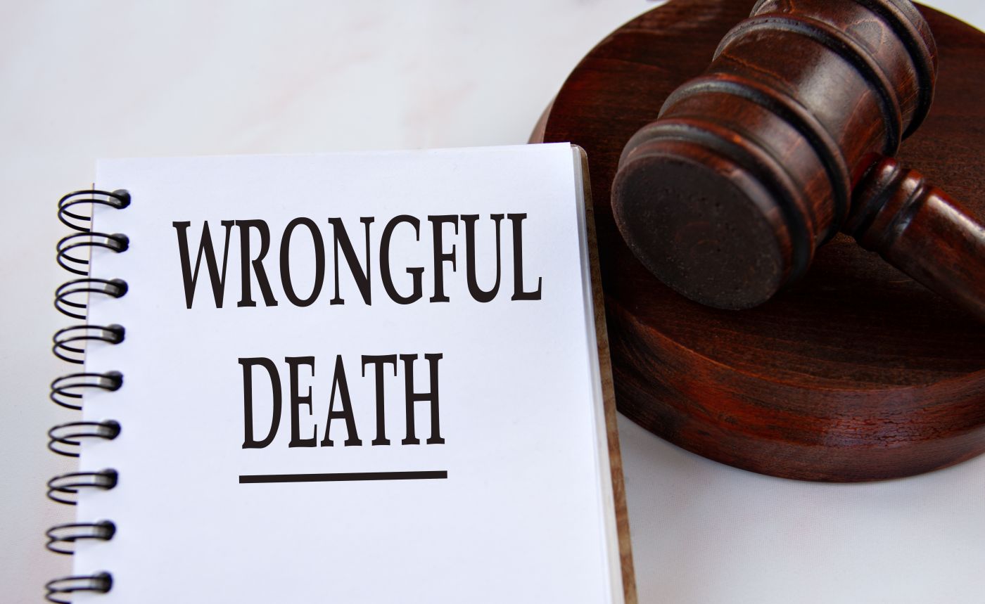 WRONGFUL DEATH word in a white notebook with gavel