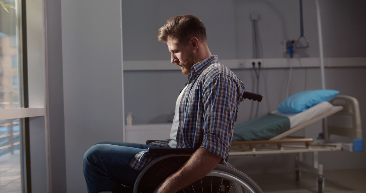 Paralyzed man in wheelchair in hospital