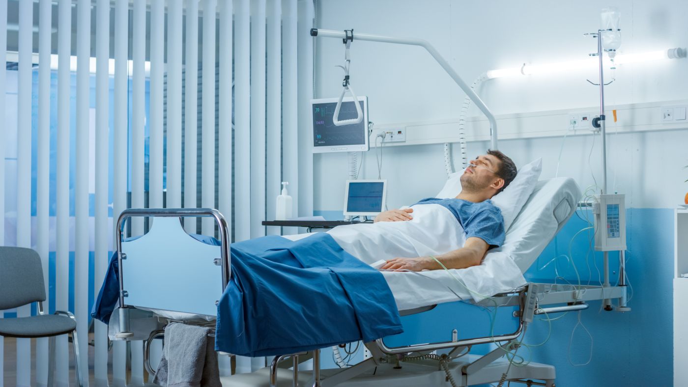 Injured man in hospital bed