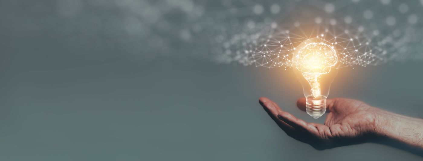 Man holding light bulb with glowing mind