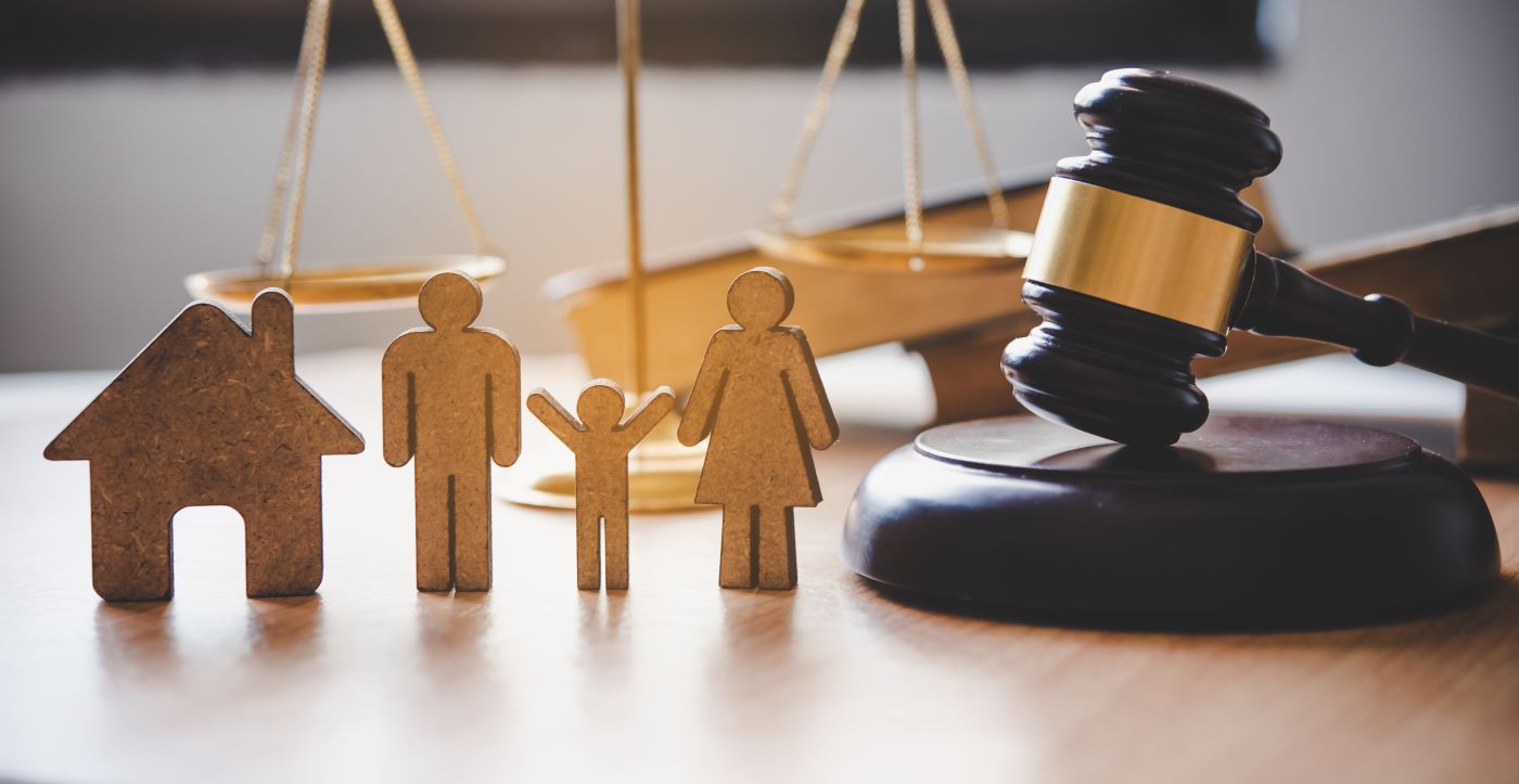 Family figures and gavel in table