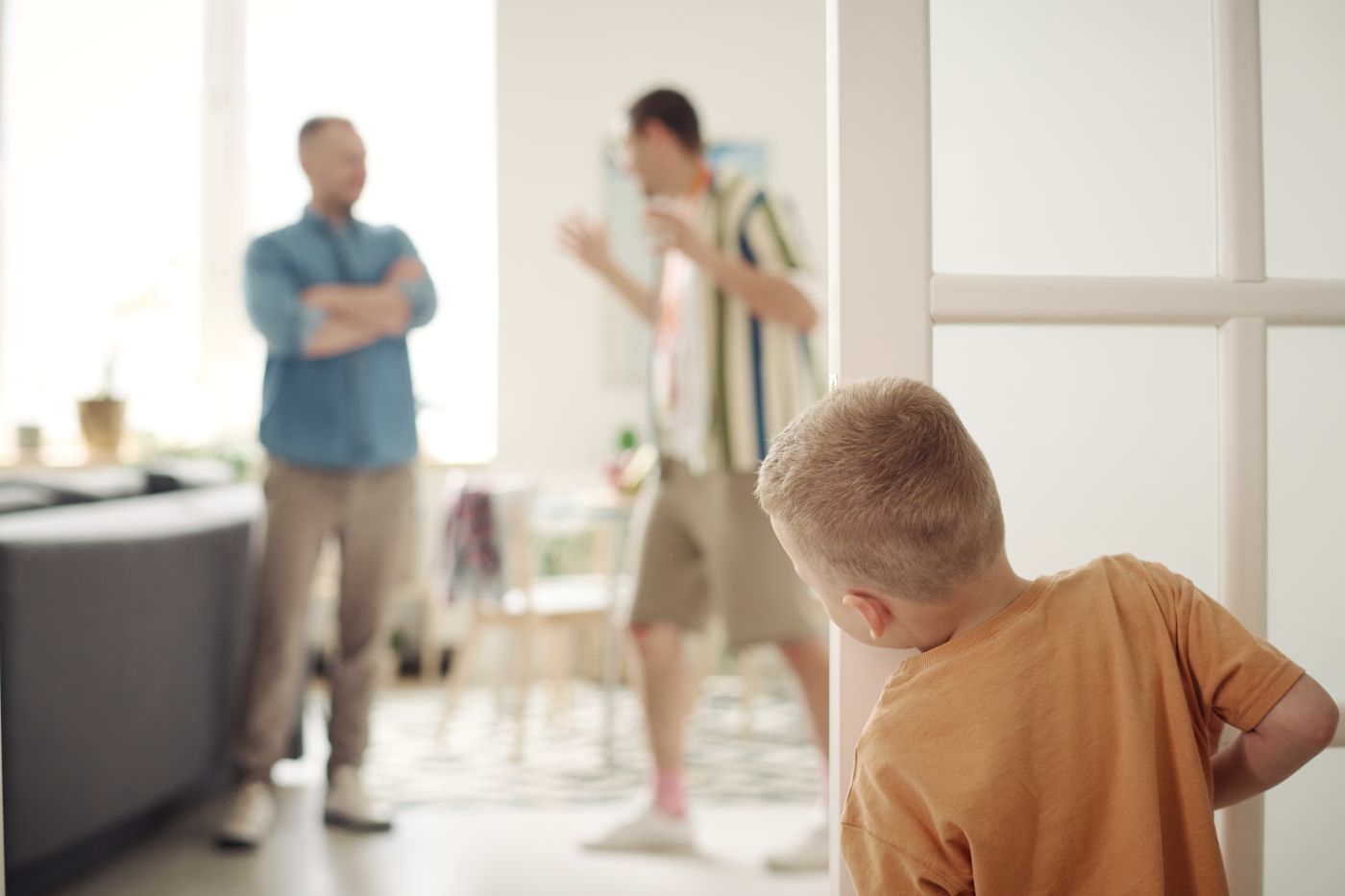 Little boy looking at his Dad's fighting
