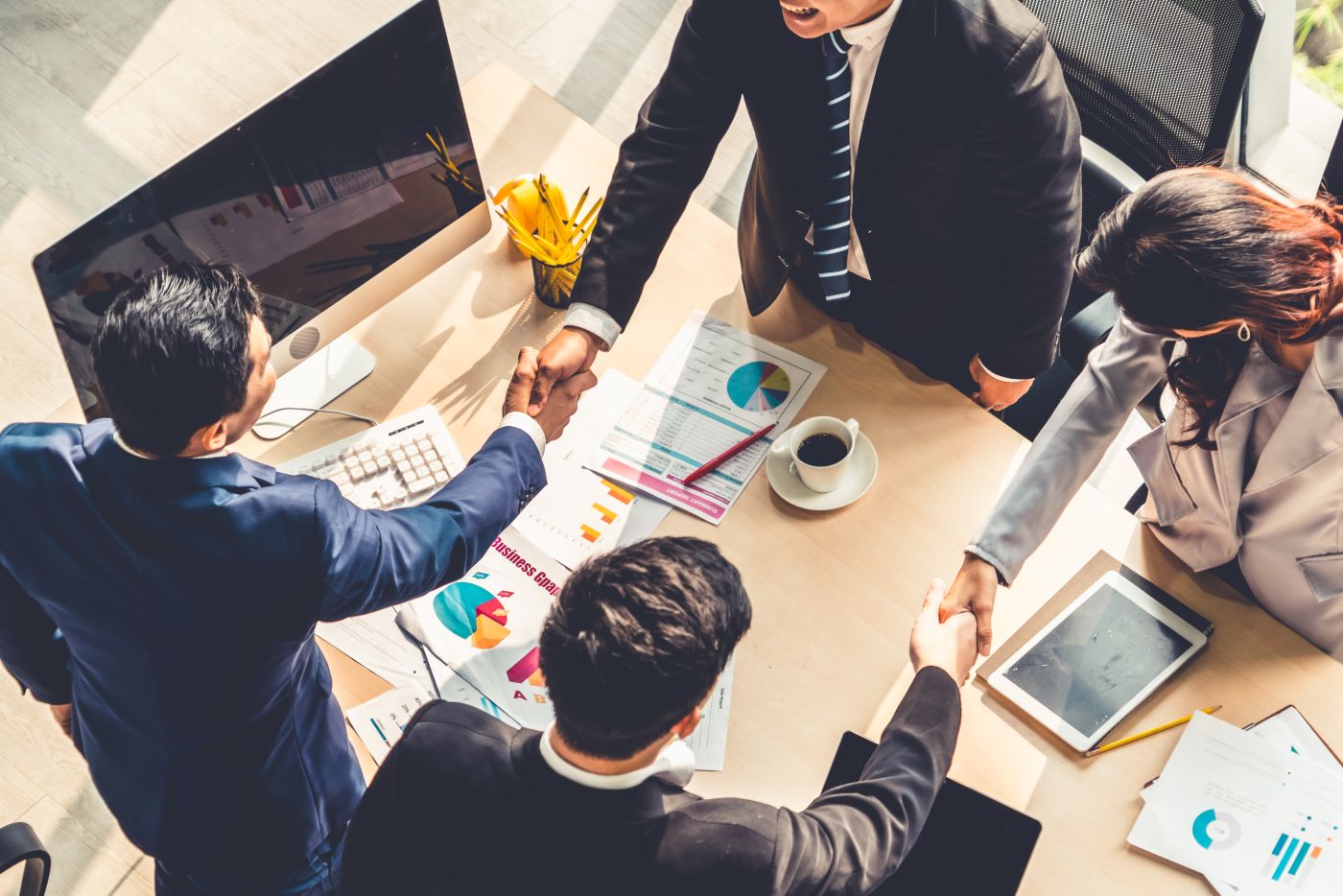 Group of businesspeople shaking hand after successful agreement