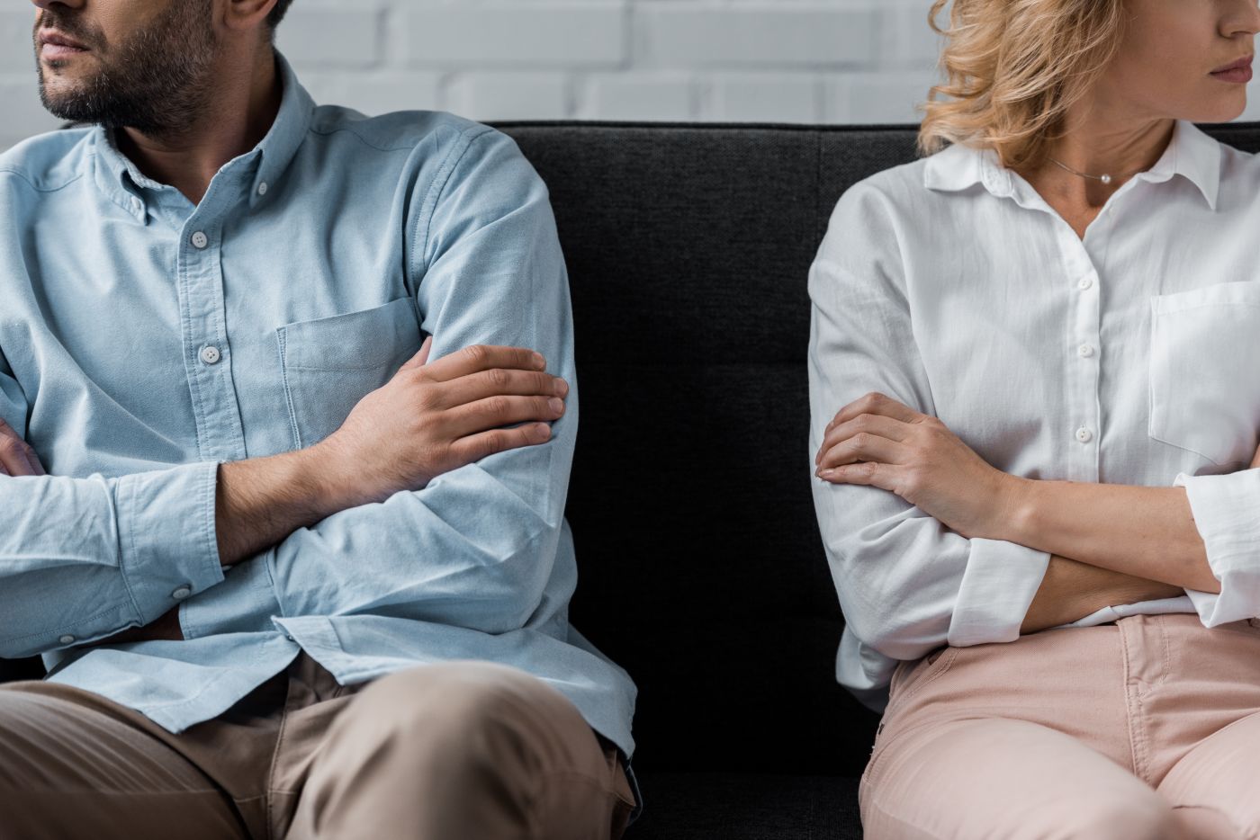 Cropped shot of couple sitting on couch after quarrel