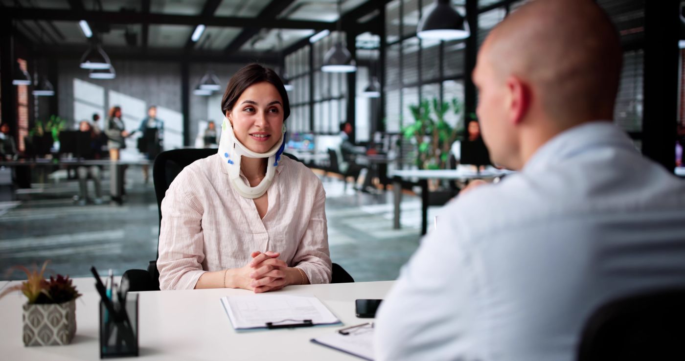 Injured women consulting with insurance agent