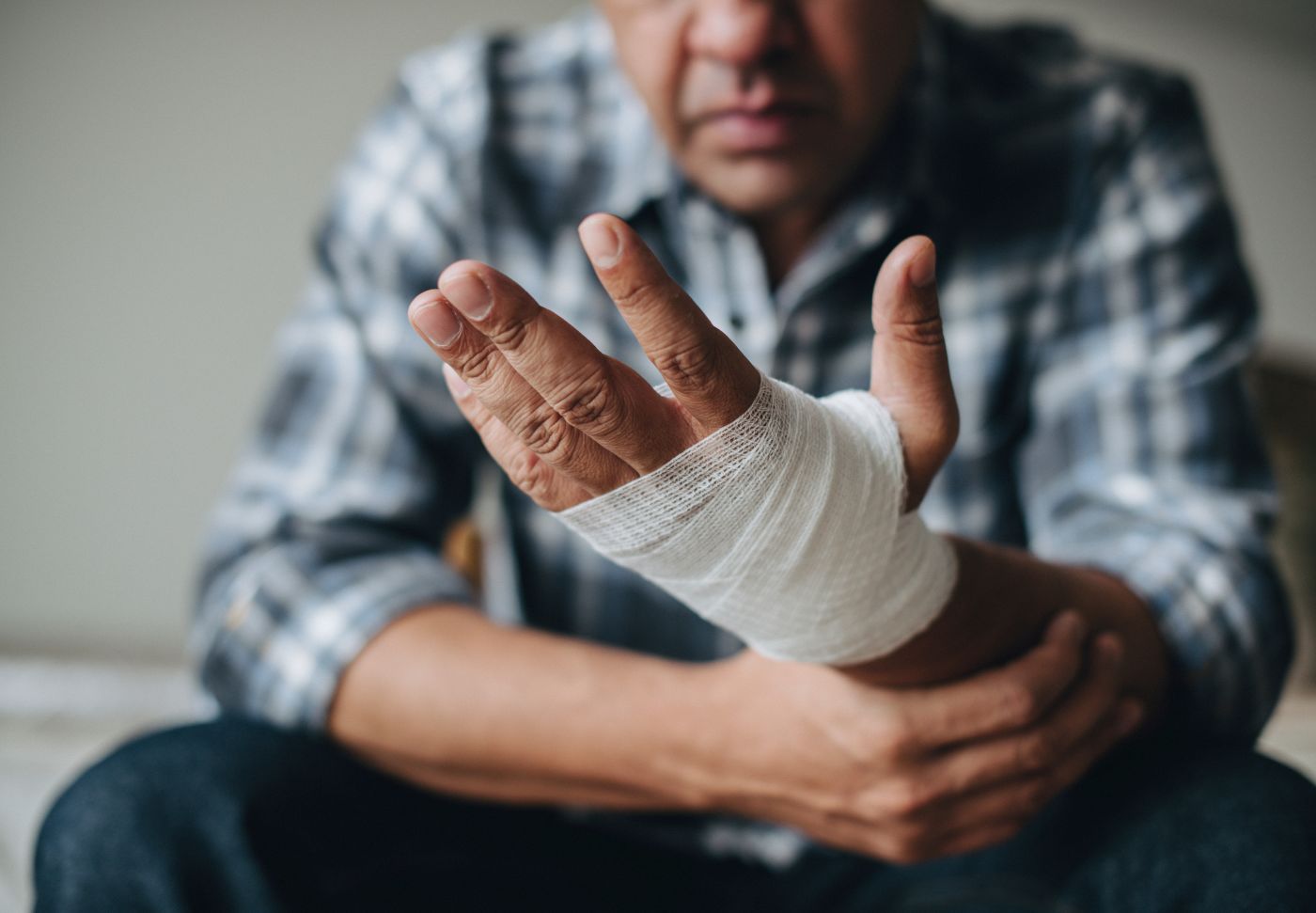 Man with a gauze bandage wrapped around his hand