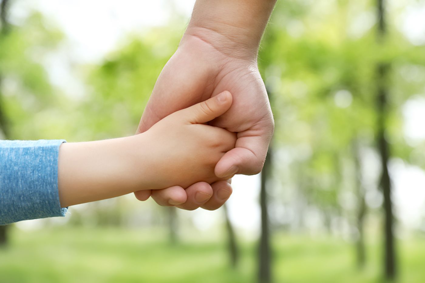 Child holding onto parent hand