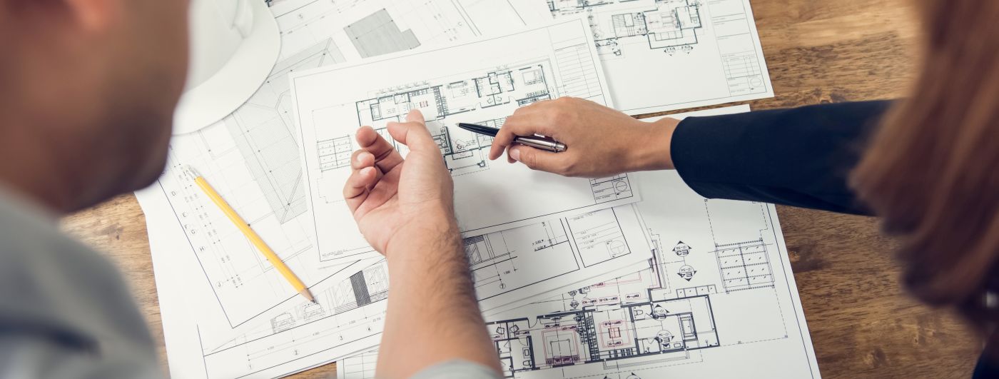 Constructor and engineer discussing design layouts before construction