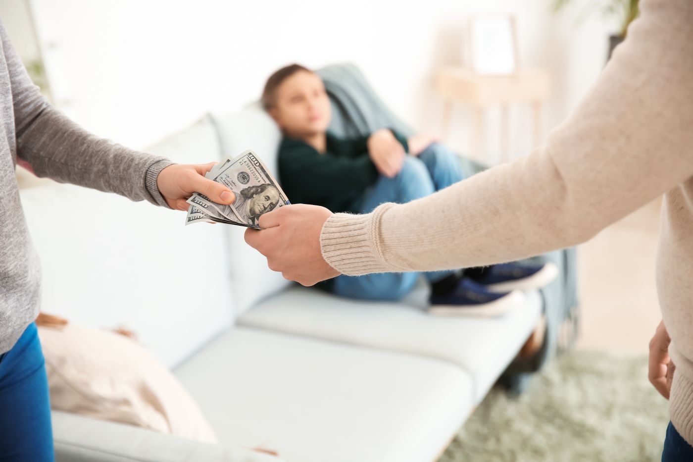Man handing spousal support money to ex spouse